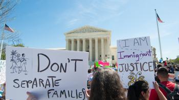 Photo from rally with "I am Immigrant Justice" poster