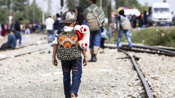 Child walking on train tracks