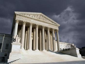 Supreme Court building with dark clouds