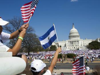 Family waving flags in front of White House